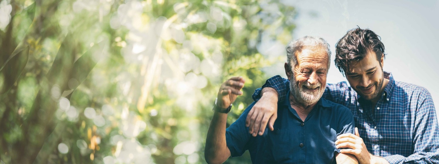 A man side hugging an old man